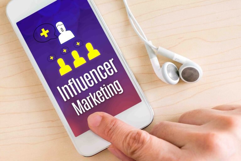 Hand touch smart phone and ear phone with Influencer Marketing w